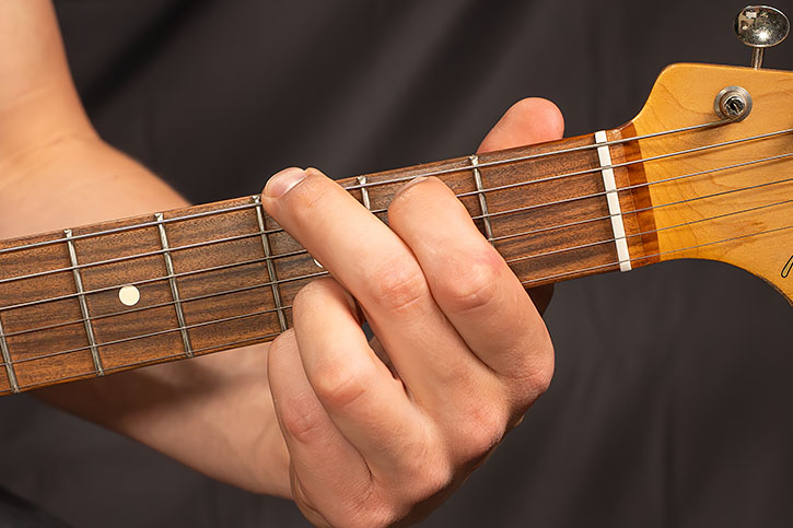 AL playing a open chord